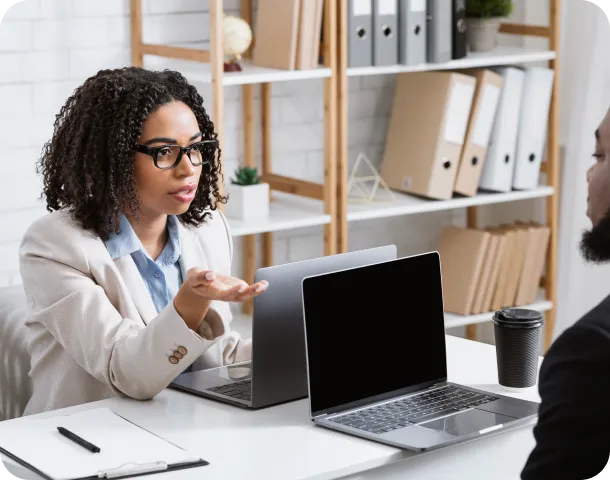serious black woman speaking to her male colleague